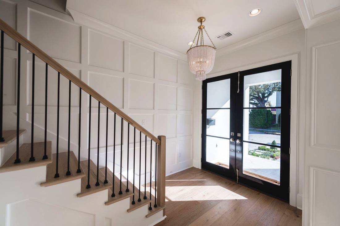 Modern staircase with paneled walls