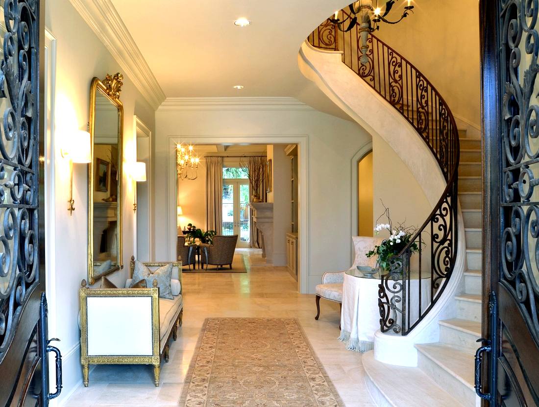 Curved staircase with ornate iron scrollwork
