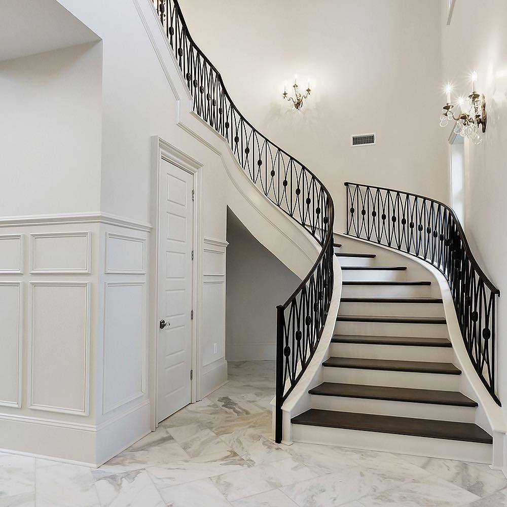 Grand sweeping iron baluster staircase