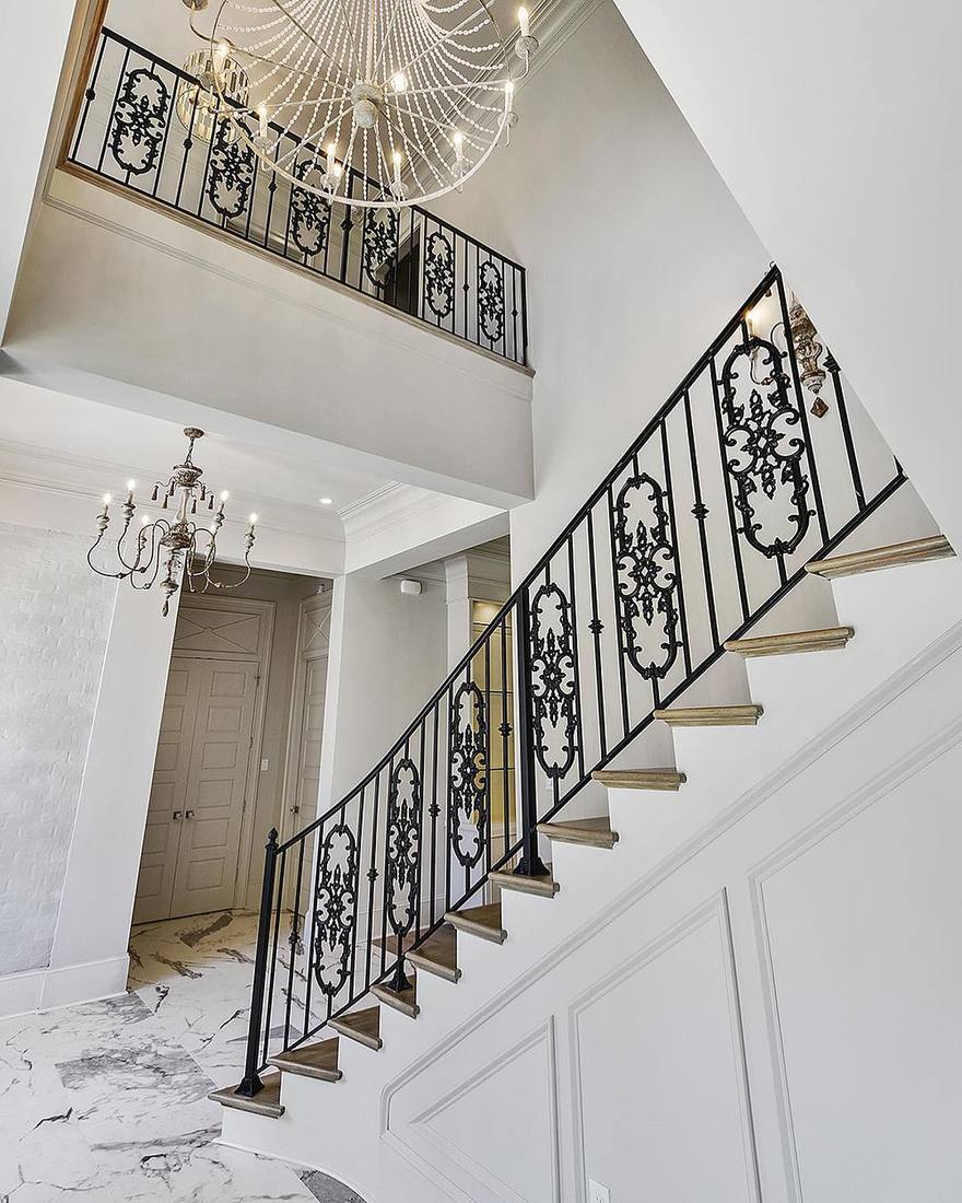 Herringbone foyer with curved stair